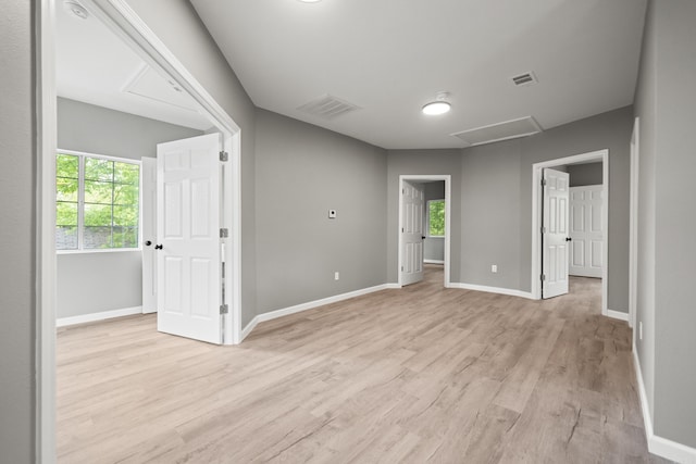 609 S St, Hot Springs, AR 71913 - spare room with light wood-type flooring, attic access, a healthy amount of sunlight, and visible vents