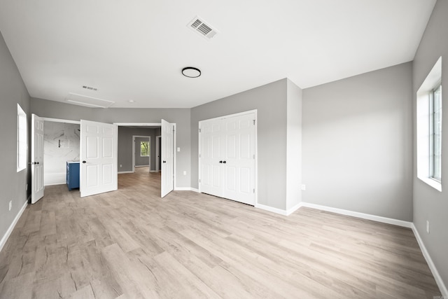 609 S St, Hot Springs, AR 71913 - unfurnished bedroom featuring visible vents, multiple windows, and light wood finished floors