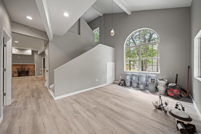 609 S St, Hot Springs, AR 71913 - unfurnished living room featuring wood finished floors, baseboards, beam ceiling, and high vaulted ceiling
