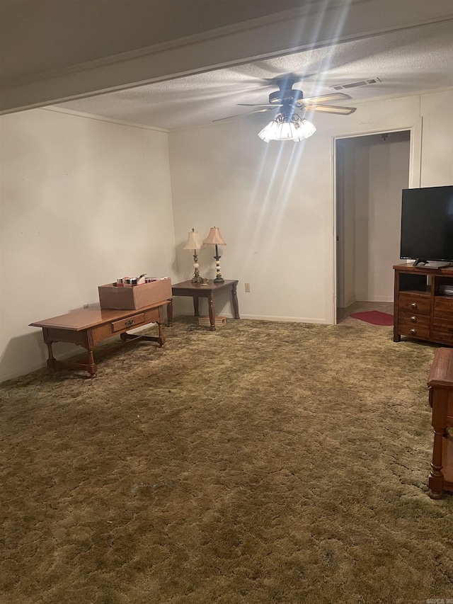 carpeted living area with a textured ceiling, ceiling fan, and visible vents