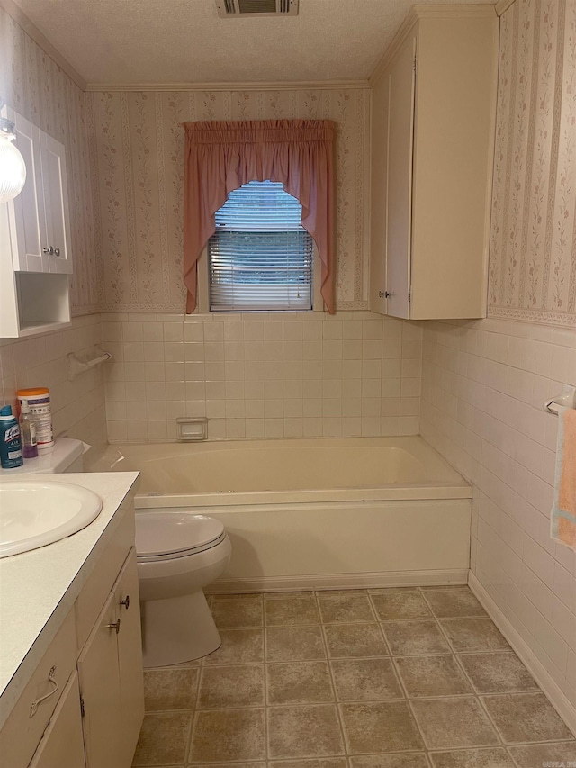 full bath featuring toilet, wallpapered walls, a tub to relax in, and vanity