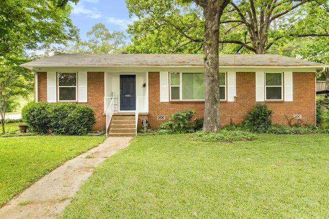 ranch-style house featuring entry steps, a front lawn, and brick siding