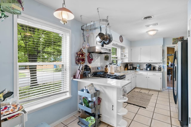 kitchen with open shelves, appliances with stainless steel finishes, white cabinetry, light tile patterned floors, and backsplash