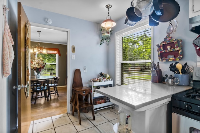 dining area featuring crown molding, light tile patterned flooring, and a notable chandelier