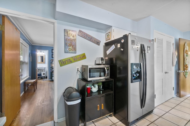 kitchen featuring white cabinets, stainless steel appliances, and baseboards