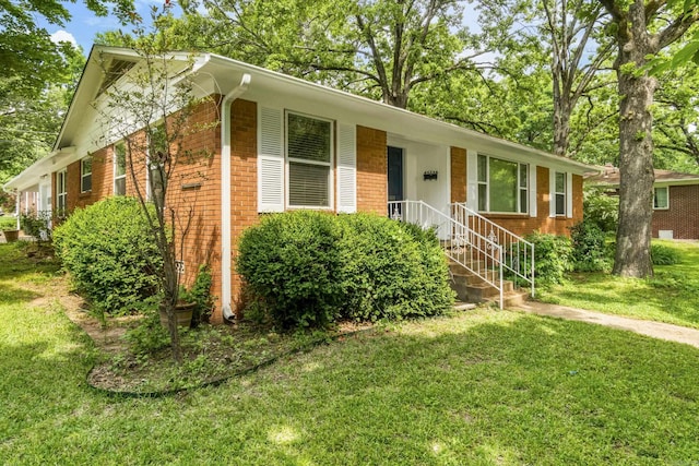 ranch-style house with brick siding and a front lawn
