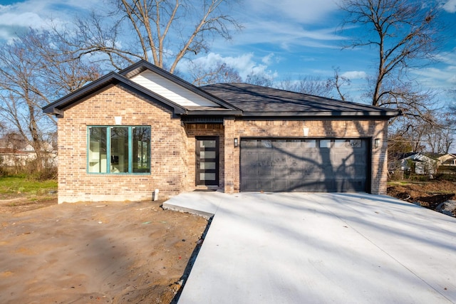 2919 Martel Ave, Little Rock, AR 72206 - view of front facade featuring brick siding, a garage, and concrete driveway