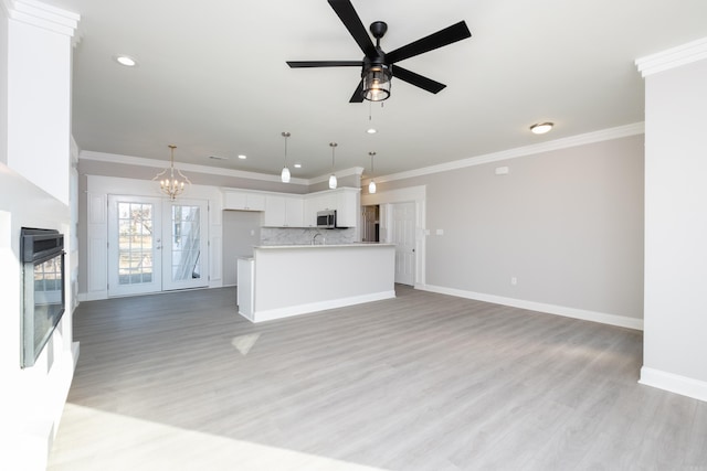 2919 Martel Ave, Little Rock, AR 72206 - kitchen featuring white cabinetry, open floor plan, and ornamental molding