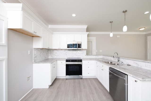 2919 Martel Ave, Little Rock, AR 72206 - kitchen with ornamental molding, a peninsula, light stone countertops, a sink, and stainless steel appliances
