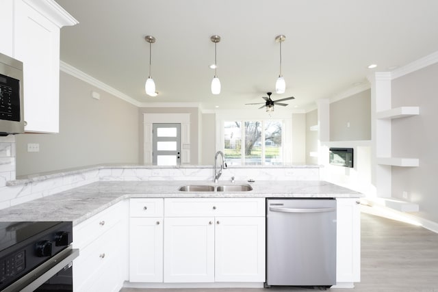 2919 Martel Ave, Little Rock, AR 72206 - kitchen featuring ornamental molding, light stone countertops, white cabinets, a sink, and appliances with stainless steel finishes