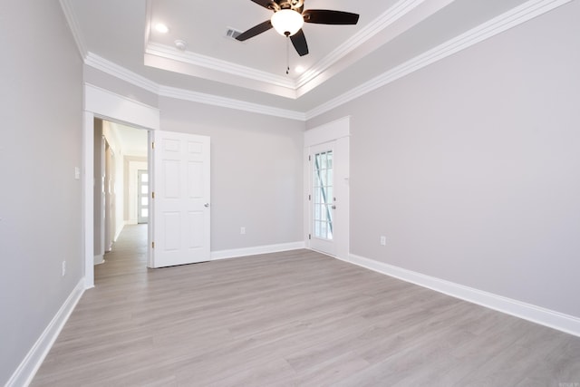 2919 Martel Ave, Little Rock, AR 72206 - empty room with ceiling fan, visible vents, a raised ceiling, light wood finished floors, and ornamental molding