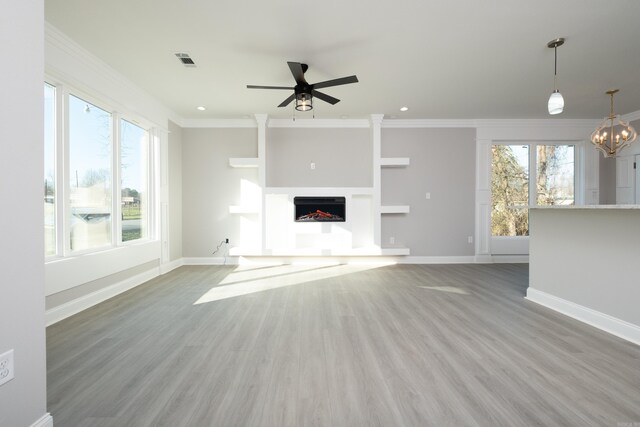 2919 Martel Ave, Little Rock, AR 72206 - unfurnished living room with ornamental molding, wood finished floors, a fireplace, baseboards, and ceiling fan with notable chandelier