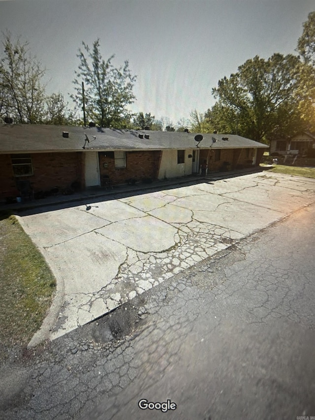 back of house featuring brick siding