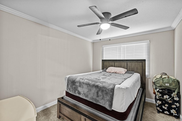 carpeted bedroom featuring crown molding, baseboards, and ceiling fan