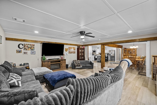 living area featuring visible vents, recessed lighting, light wood-style floors, and ceiling fan with notable chandelier