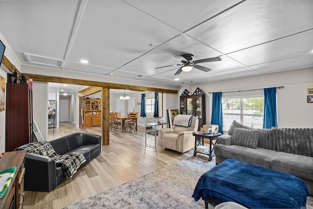 living room featuring recessed lighting, ceiling fan with notable chandelier, and light wood finished floors