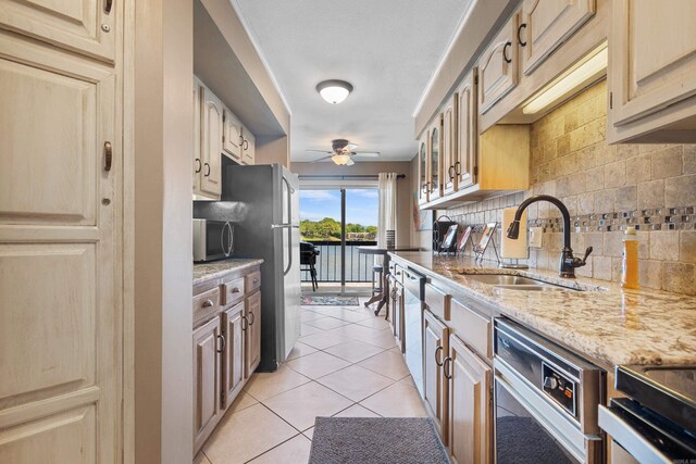101 Long Island Dr, Hot Springs, AR 71913 - kitchen featuring light stone countertops, a sink, stainless steel appliances, a ceiling fan, and decorative backsplash