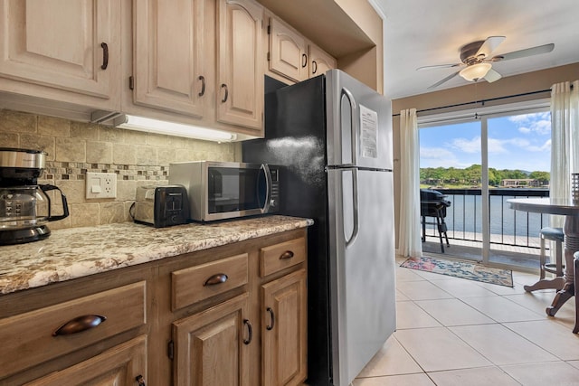 101 Long Island Dr, Hot Springs, AR 71913 - kitchen with light tile patterned flooring, a water view, tasteful backsplash, a ceiling fan, and stainless steel appliances