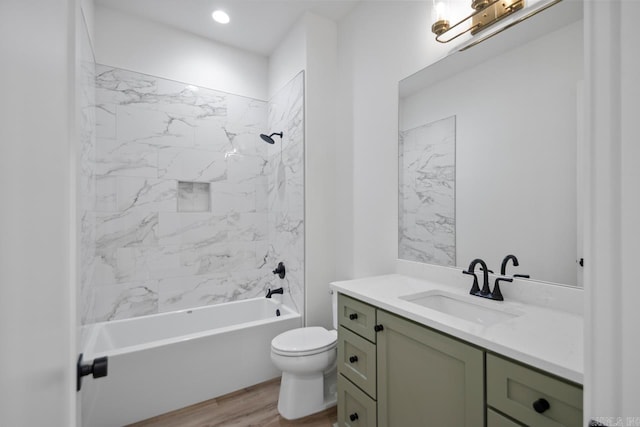 bathroom with toilet, tub / shower combination, wood finished floors, and vanity