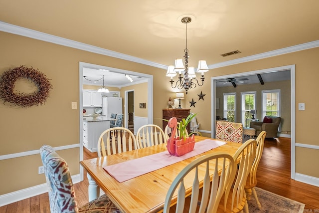 3 E Lake Dr, North Little Rock, AR 72116 - dining room with visible vents, ornamental molding, baseboards, light wood-style flooring, and ceiling fan with notable chandelier