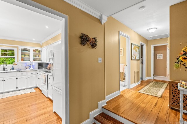 3 E Lake Dr, North Little Rock, AR 72116 - entryway with crown molding, baseboards, a sink, and light wood finished floors