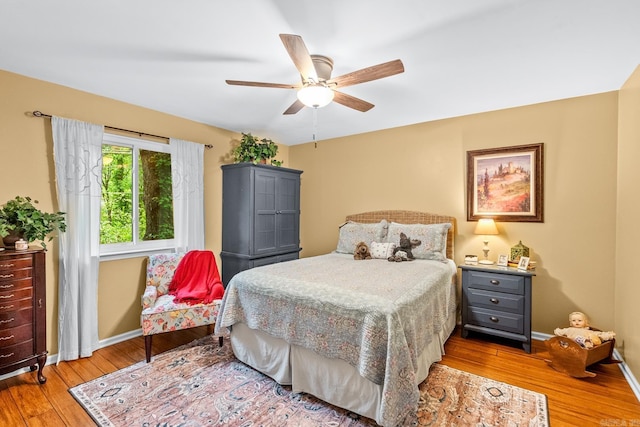 bedroom with baseboards, a ceiling fan, and wood finished floors