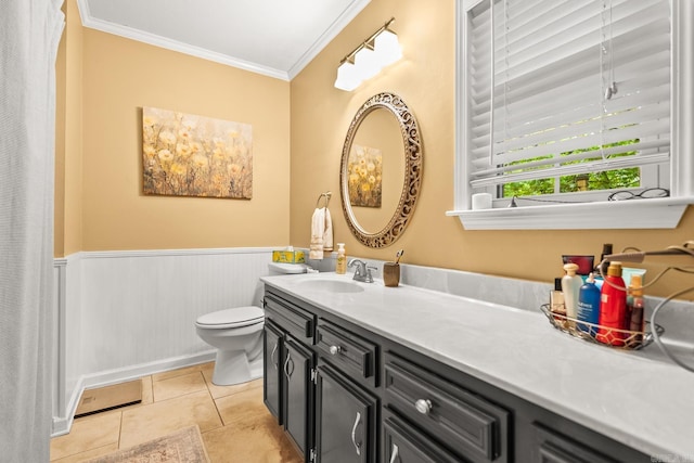 full bath with wainscoting, tile patterned flooring, vanity, toilet, and ornamental molding