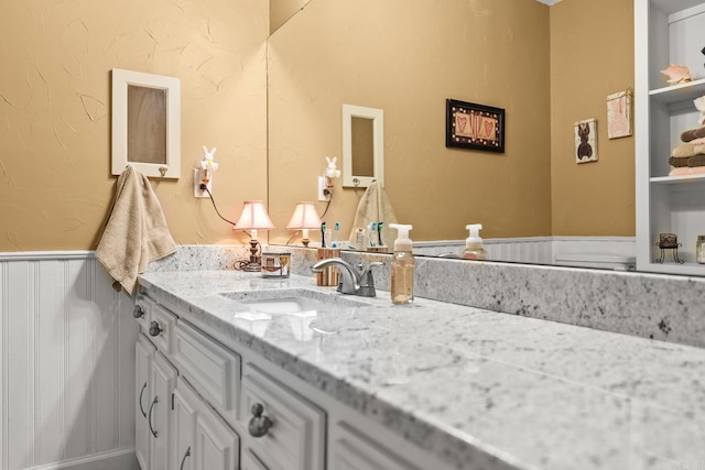 bathroom featuring vanity and wainscoting