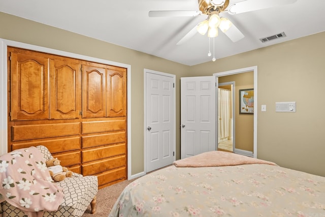 carpeted bedroom featuring visible vents, a ceiling fan, and baseboards