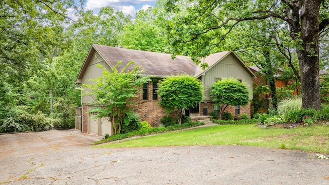 3 E Lake Dr, North Little Rock, AR 72116 - view of front facade with brick siding, a garage, a front yard, and concrete driveway