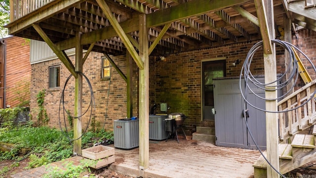 view of patio with central air condition unit and a wooden deck