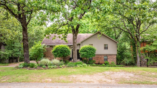 view of front of property with brick siding and a front lawn