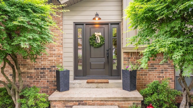 entrance to property with brick siding