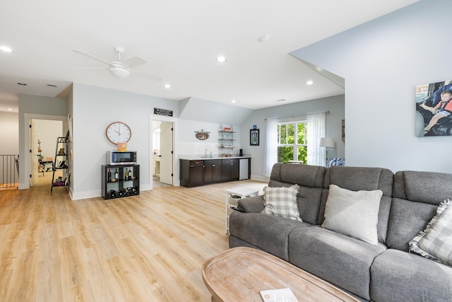 living room with ceiling fan, baseboards, light wood finished floors, indoor bar, and recessed lighting