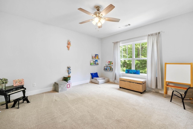 interior space featuring visible vents, carpet flooring, baseboards, and ceiling fan