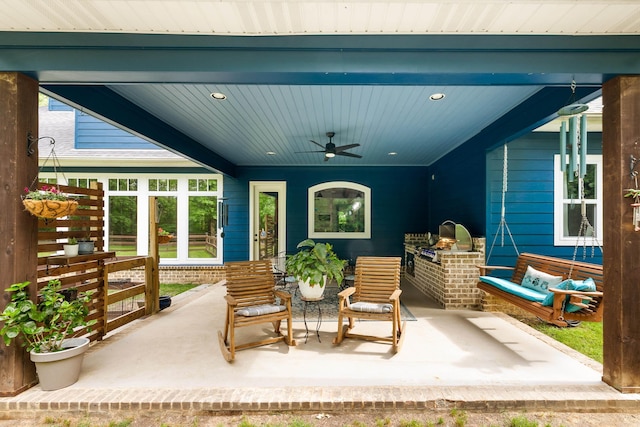view of patio featuring an outdoor kitchen and ceiling fan