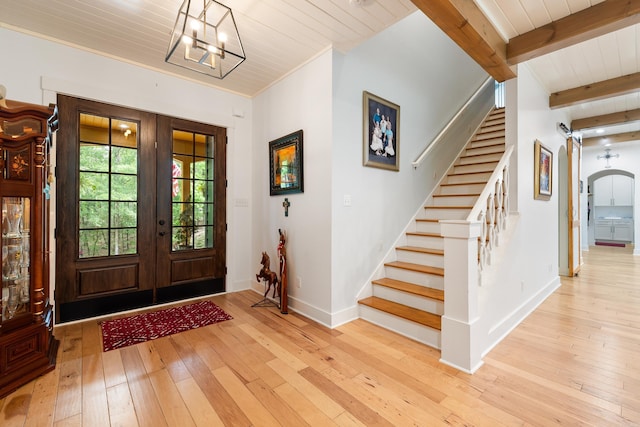 foyer featuring french doors, stairs, baseboards, and hardwood / wood-style flooring