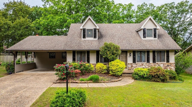 22 Colony Rd, Little Rock, AR 72227 - view of front facade featuring driveway, a front yard, roof with shingles, a carport, and stone siding