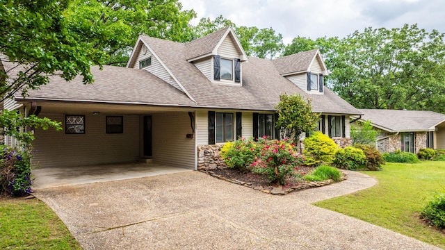 22 Colony Rd, Little Rock, AR 72227 - new england style home featuring concrete driveway, a shingled roof, a front yard, and an attached carport