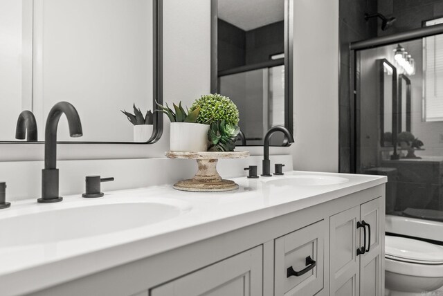 22 Colony Rd, Little Rock, AR 72227 - bathroom with double vanity, a sink, and toilet