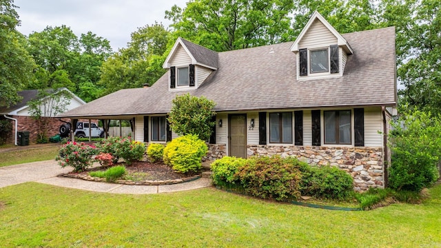 22 Colony Rd, Little Rock, AR 72227 - view of front of property with a shingled roof, a front lawn, stone siding, and concrete driveway
