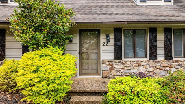 22 Colony Rd, Little Rock, AR 72227 - doorway to property with roof with shingles, covered porch, and stone siding