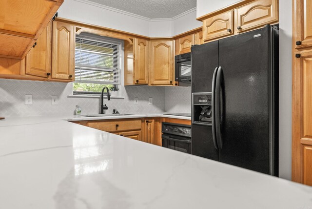 22 Colony Rd, Little Rock, AR 72227 - kitchen featuring backsplash, a textured ceiling, a sink, light countertops, and black appliances