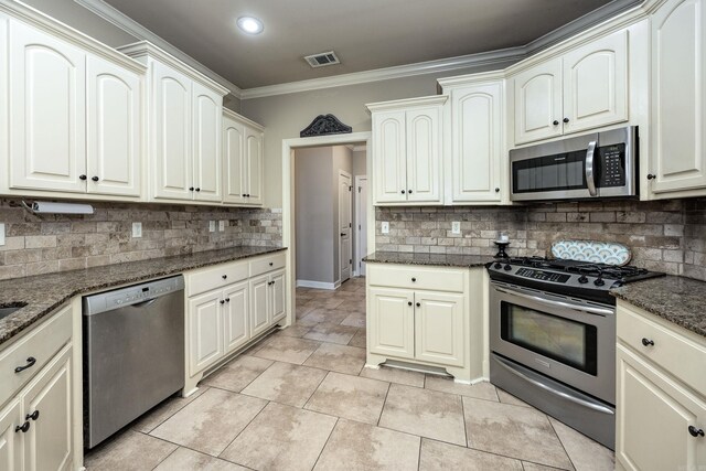 26 Epernay Cir, Little Rock, AR 72223 - kitchen with decorative backsplash, visible vents, crown molding, dark stone countertops, and stainless steel appliances