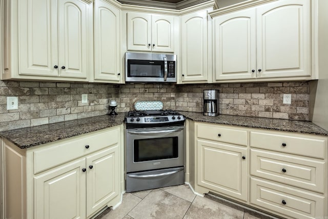 26 Epernay Cir, Little Rock, AR 72223 - kitchen with backsplash, light tile patterned flooring, cream cabinetry, and stainless steel appliances