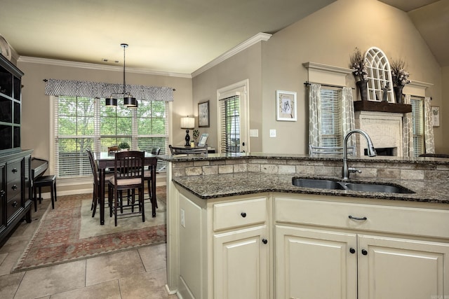 26 Epernay Cir, Little Rock, AR 72223 - kitchen with a sink, dark stone countertops, decorative light fixtures, visible vents, and ornamental molding