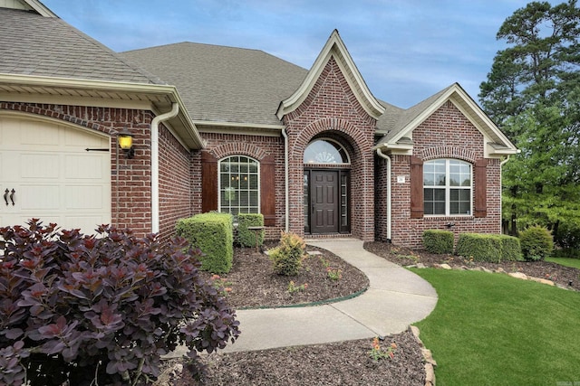 26 Epernay Cir, Little Rock, AR 72223 - exterior space featuring a lawn, brick siding, a shingled roof, and a garage