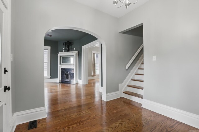 interior space with stairway, baseboards, wood finished floors, and a chandelier