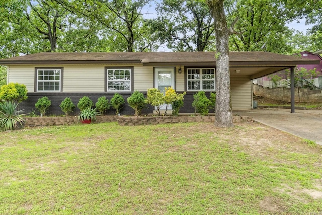 ranch-style house with fence, a carport, driveway, and a front yard