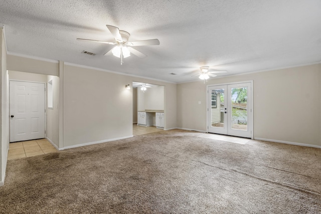 interior space with visible vents, ornamental molding, light carpet, french doors, and a ceiling fan